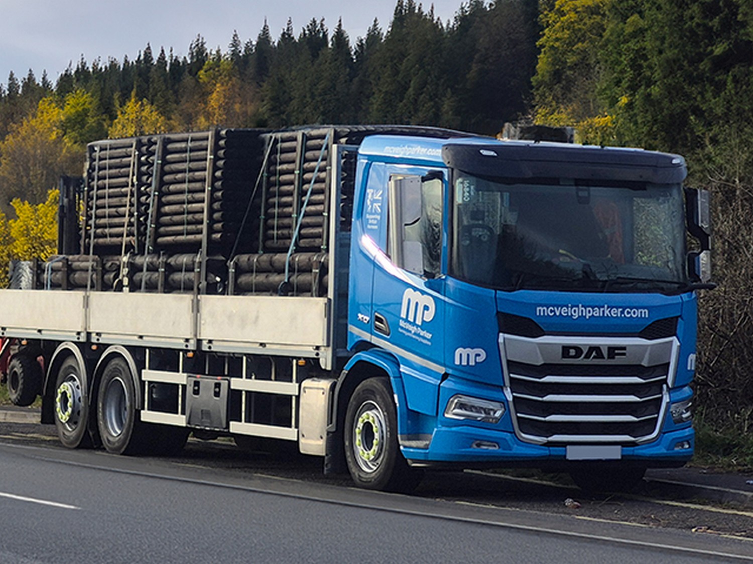 A McVeigh Parker delivery lorry loaded with timber on the road in Sussex