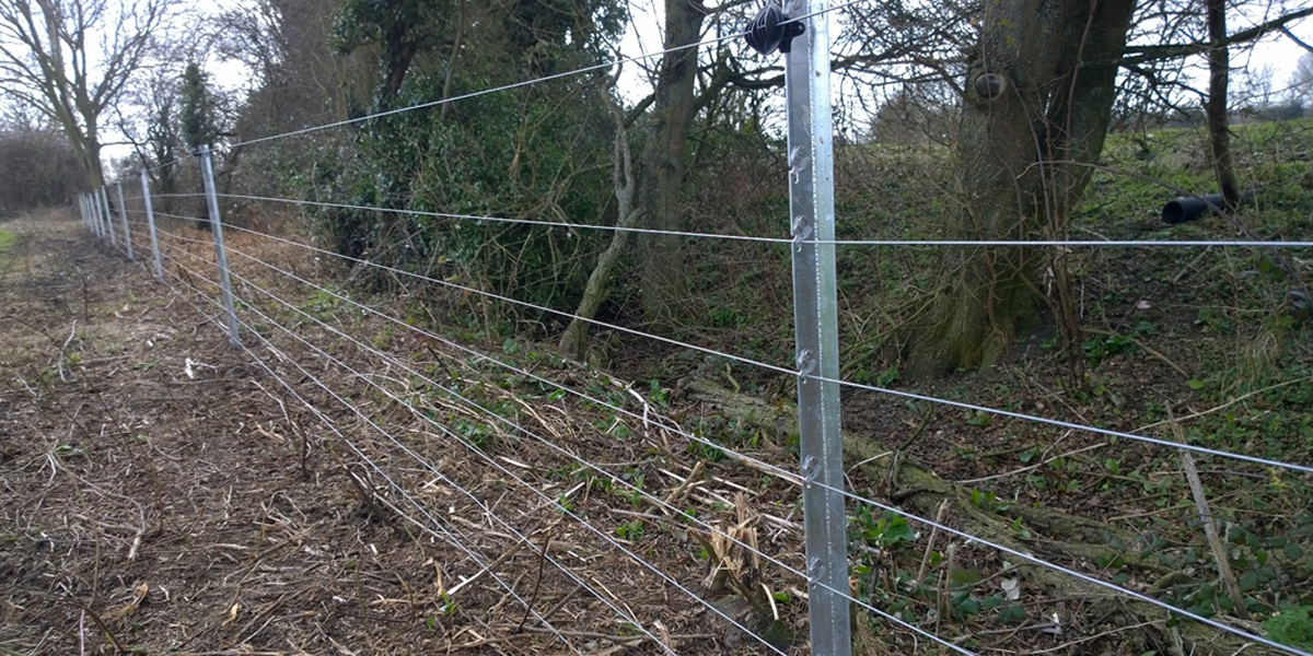 Flood Fence – Field riverside at Carrant Brook in Gloucestershire.